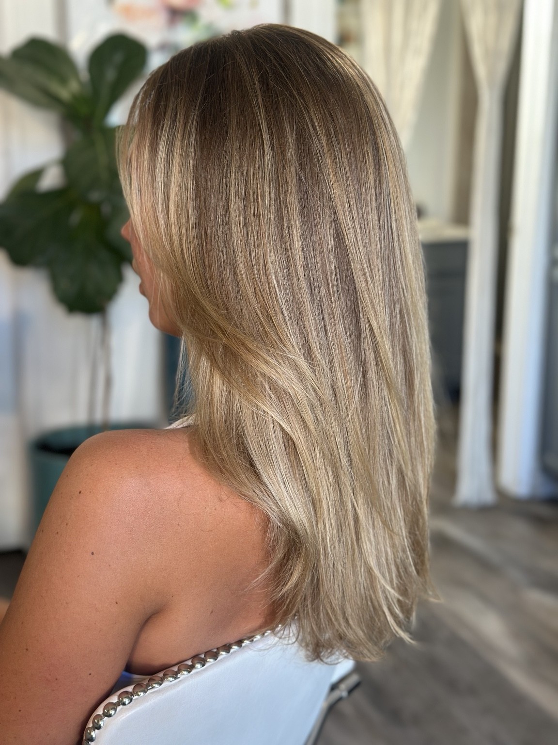 Layered hair with soft face framing and dimensional color, hair by Brandy Michele