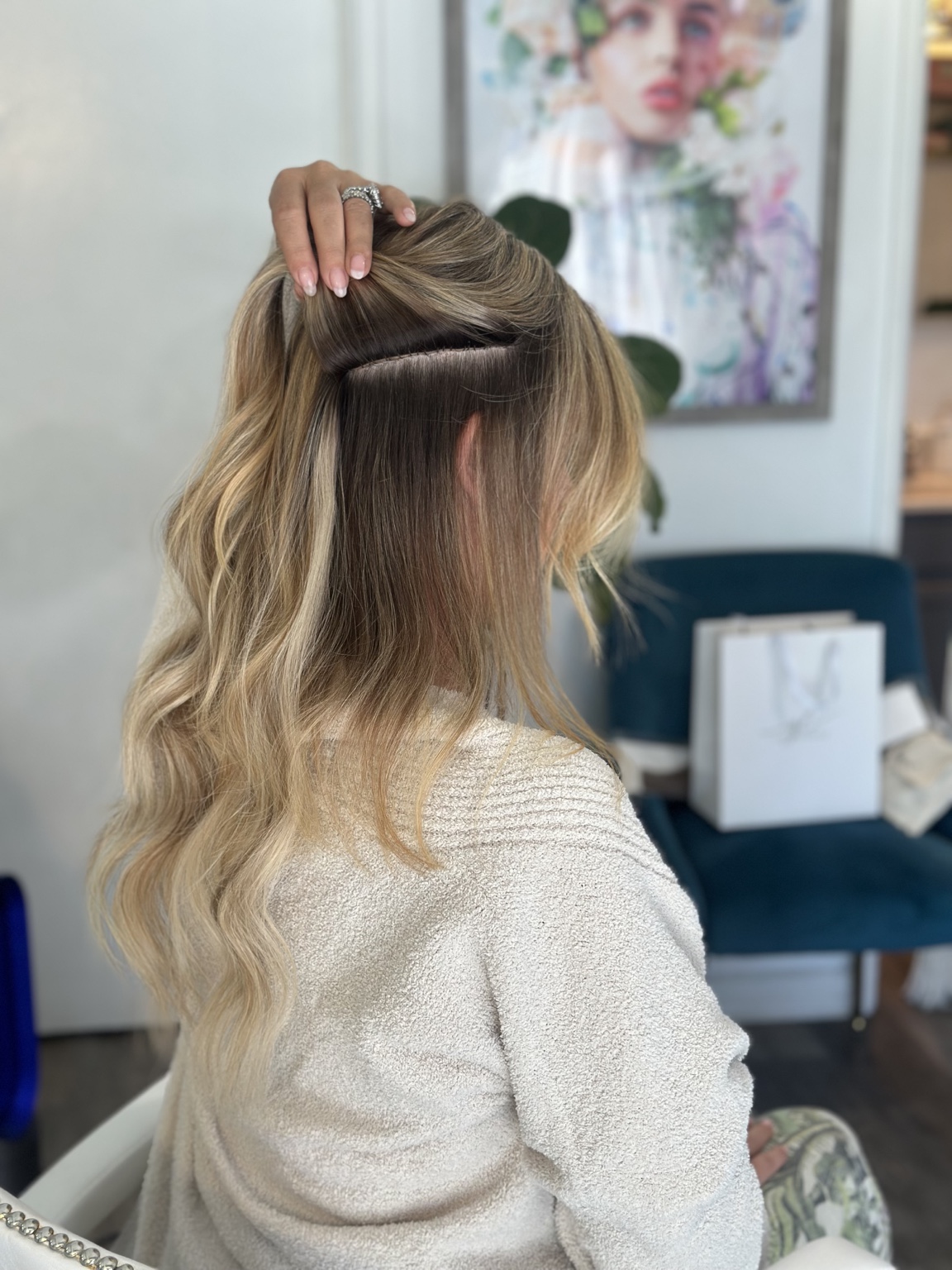 Blonde hair lifted to reveal a neatly concealed extension row, hair by Brandy Michele